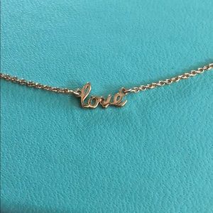 “Love” pendant necklace on gold metal chain
